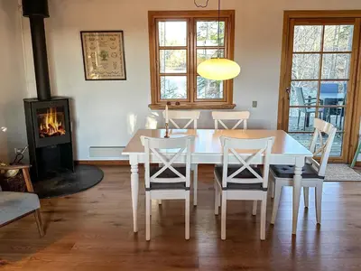 a dining room with a table and chairs and a fireplace at 4 person holiday home in Aars-By Traum in Års