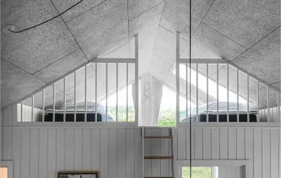 two beds in a room with two windows at Amazing Home In Harboøre With 4 Bedrooms, Sauna & Wifi in Harboør
