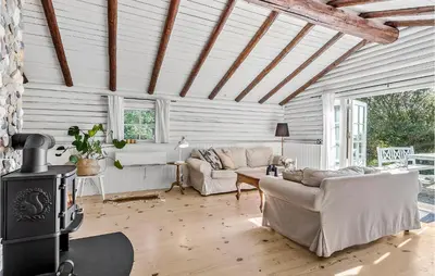 a living room with couches and a wood stove at 3 Bedroom Cozy Home In Hurup Thy in Sønder Ydby