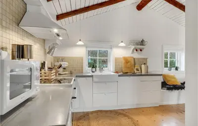 a large white kitchen with white cabinets and appliances at 3 Bedroom Cozy Home In Hurup Thy in Sønder Ydby