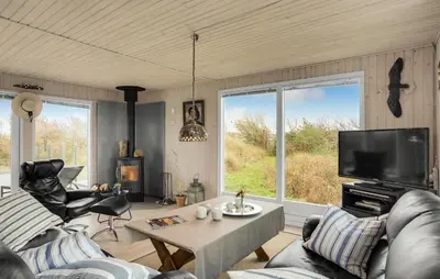 a living room with a couch and a tv at Stunning Home In Løkken With Kitchen in Løkken