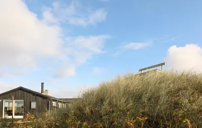 a house on top of a hill with grass at Stunning Home In Løkken With Kitchen in Løkken