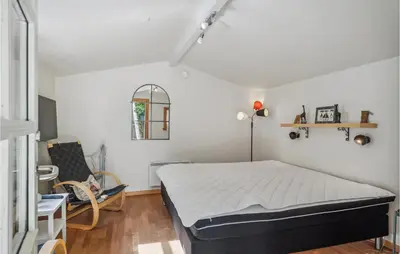 a bedroom with a bed and a chair in it at Holiday Home Jelsevej Ix in Højslev
