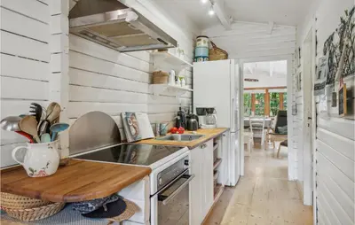 a kitchen with white walls and a wooden counter top at Holiday Home Jelsevej Ix in Højslev