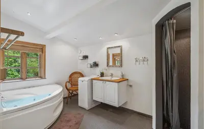 a bathroom with a tub and a toilet and a sink at Holiday Home Jelsevej Ix in Højslev