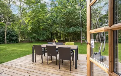 a wooden deck with a table and chairs on it at Holiday Home Jelsevej Ix in Højslev