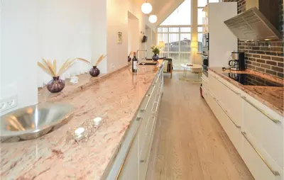 a kitchen with a sink and a counter top at Holiday Home Ved Stranden in Blokhus