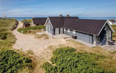 an aerial view of a house on a beach at Holiday Home Ved Stranden in Blokhus