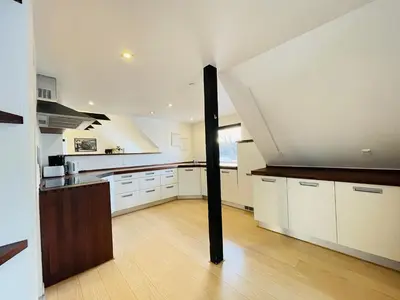 a large kitchen with white cabinets and a black pole at aday - 3 bedrooms luxurious apartment in Svenstrup in Svenstrup