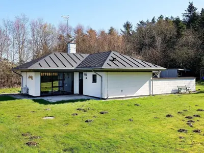 a white house with a black roof in a field at 6 person holiday home in Vesløs-By Traum in Øsløs