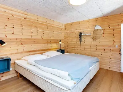 a bedroom with a bed in a wooden wall at 6 person holiday home in Vesløs-By Traum in Øsløs
