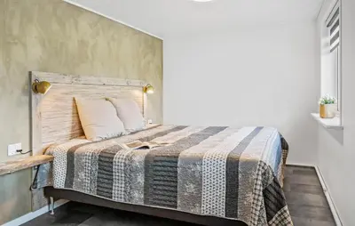 a bedroom with a bed with a blanket on it at 3 Bedroom Nice Home In Thyborøn in Thyborøn