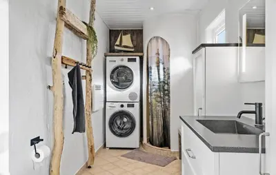 a white laundry room with a washer and dryer at 3 Bedroom Nice Home In Thyborøn in Thyborøn