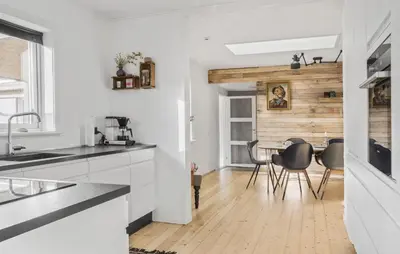 a kitchen with white walls and a table with chairs at 3 Bedroom Nice Home In Thyborøn in Thyborøn