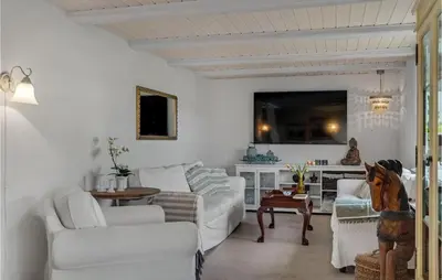 a living room with white furniture and a table at 3 Bedroom Gorgeous Home In Vestervig in Vestervig