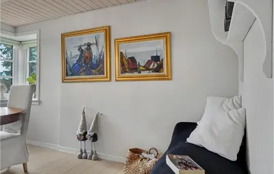 a living room with two pictures on the wall at 3 Bedroom Gorgeous Home In Vestervig in Vestervig