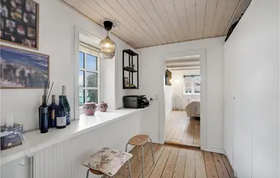 a living room with white walls and a counter with wine bottles at 3 Bedroom Gorgeous Home In Vestervig in Vestervig
