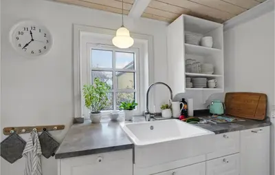 a kitchen with a sink and a clock on the wall at 3 Bedroom Gorgeous Home In Vestervig in Vestervig