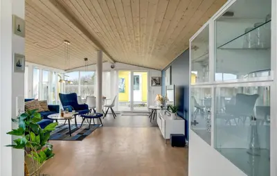 a living room with a couch and a table at 3 Bedroom Amazing Home In Spøttrup in Spottrup
