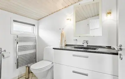a white bathroom with a toilet and a sink at 3 Bedroom Amazing Home In Spøttrup in Spottrup