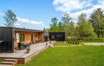 a house with a wooden deck in a yard at 4 Bedroom Gorgeous Home In Fur in Furland
