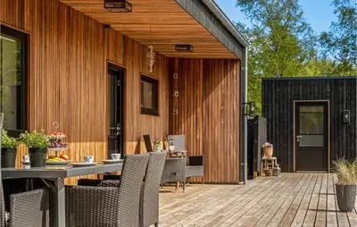 a patio with a table and chairs on a deck at 4 Bedroom Gorgeous Home In Fur in Furland