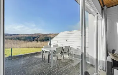 a patio with a table and chairs on a balcony at Gorgeous Apartment In Vestervig in Vestervig