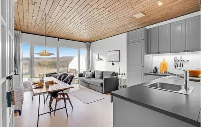 a kitchen and living room with a couch and a table at Gorgeous Apartment In Vestervig in Vestervig