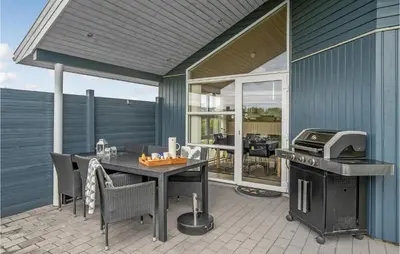 a patio with a grill and a table and chairs at Stunning Home In Lemvig With Wifi in Lemvig