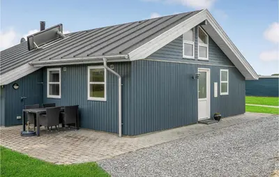 a green storage shed with a table in front of it at Stunning Home In Lemvig With Wifi in Lemvig