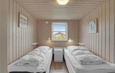 a row of beds in a room with a window at Stunning Home In Lemvig With Wifi in Lemvig