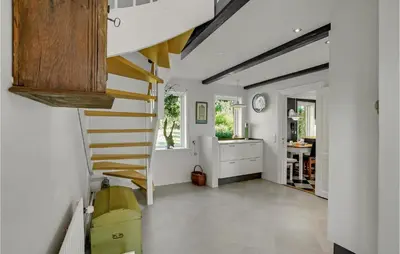 a hallway with a staircase in a house at 5 Bedroom Awesome Home In Erslev in Erslev