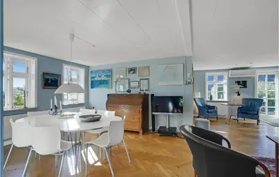 a living room with a white table and chairs at 5 Bedroom Awesome Home In Erslev in Erslev