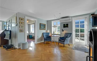 a living room with two chairs and a table at 5 Bedroom Awesome Home In Erslev in Erslev