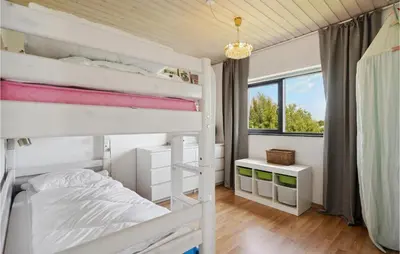 a bedroom with two bunk beds and a window at Nice Home In Øster Assels With Wifi in Øster Assels