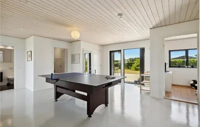 a room with a ping pong table in it at Nice Home In Øster Assels With Wifi in Øster Assels