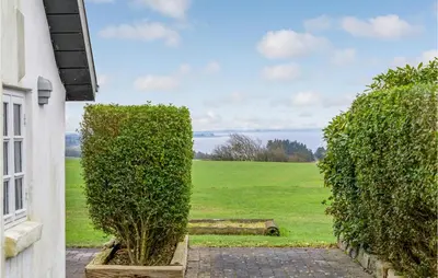 a view of a field from a house with hedges at Nice Home In Erslev With Wifi in Erslev