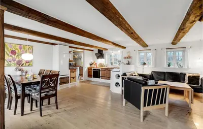 a kitchen and living room with a table and a couch at Nice Home In Erslev With Wifi in Erslev