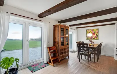 a dining room with a table and chairs and a window at Nice Home In Erslev With Wifi in Erslev