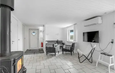 a living room with a fireplace and a tv at Cozy Home In Thisted With Wifi in Thisted