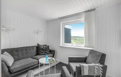 a living room with a couch and a chair and a table at Cozy Home In Thisted With Wifi in Thisted