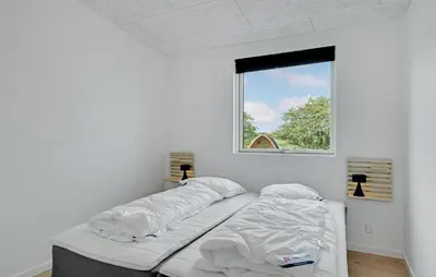 a bed in a room with a window at Nice Home In Spøttrup With Sauna in Spottrup