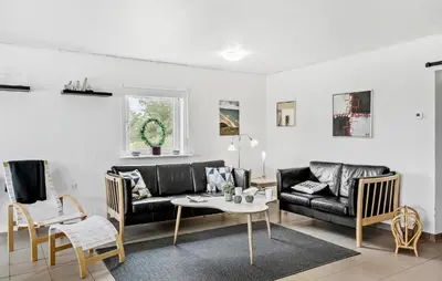 a living room with a couch and a table at 3 Bedroom Amazing Home In Vesløs in Øsløs