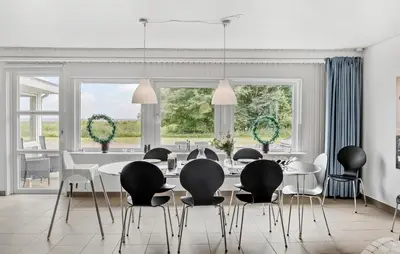a dining room with a table and chairs at 3 Bedroom Amazing Home In Vesløs in Øsløs