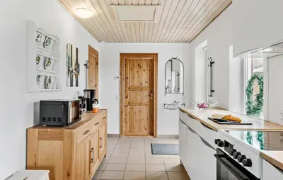 a kitchen with white walls and a wooden ceiling at 3 Bedroom Amazing Home In Vesløs in Øsløs