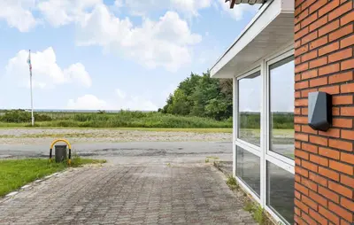 a brick building with a window and a driveway at 3 Bedroom Amazing Home In Vesløs in Øsløs