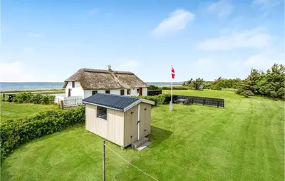 a small house in the middle of a field at Gorgeous Home In Thyholm With Kitchen in Thyholm