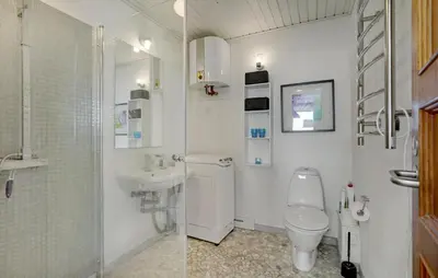 two pictures of a bathroom with a toilet and a sink at 2 Bedroom Nice Home In Roslev in Roslev