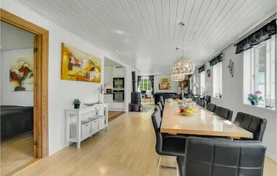 a dining room with a long table and black chairs at Amazing Home In Vestervig With Sauna in Vestervig
