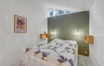 a bedroom with a bed with a quilt on it at Pet Friendly Home In Spøttrup With Wifi in Spottrup